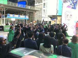 A large group of the WEBTOON staff present at the TOON SQUARE event cheer in unison