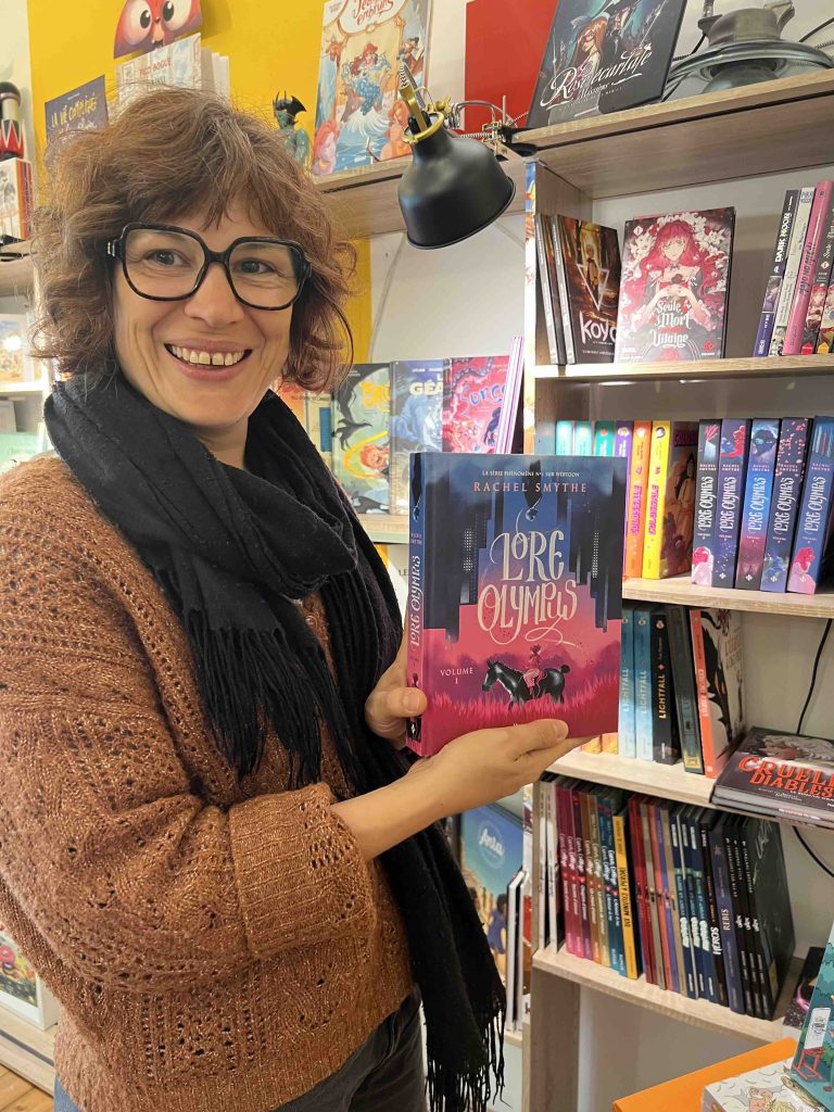 Marjorie shows off a copy of Lore Olympus