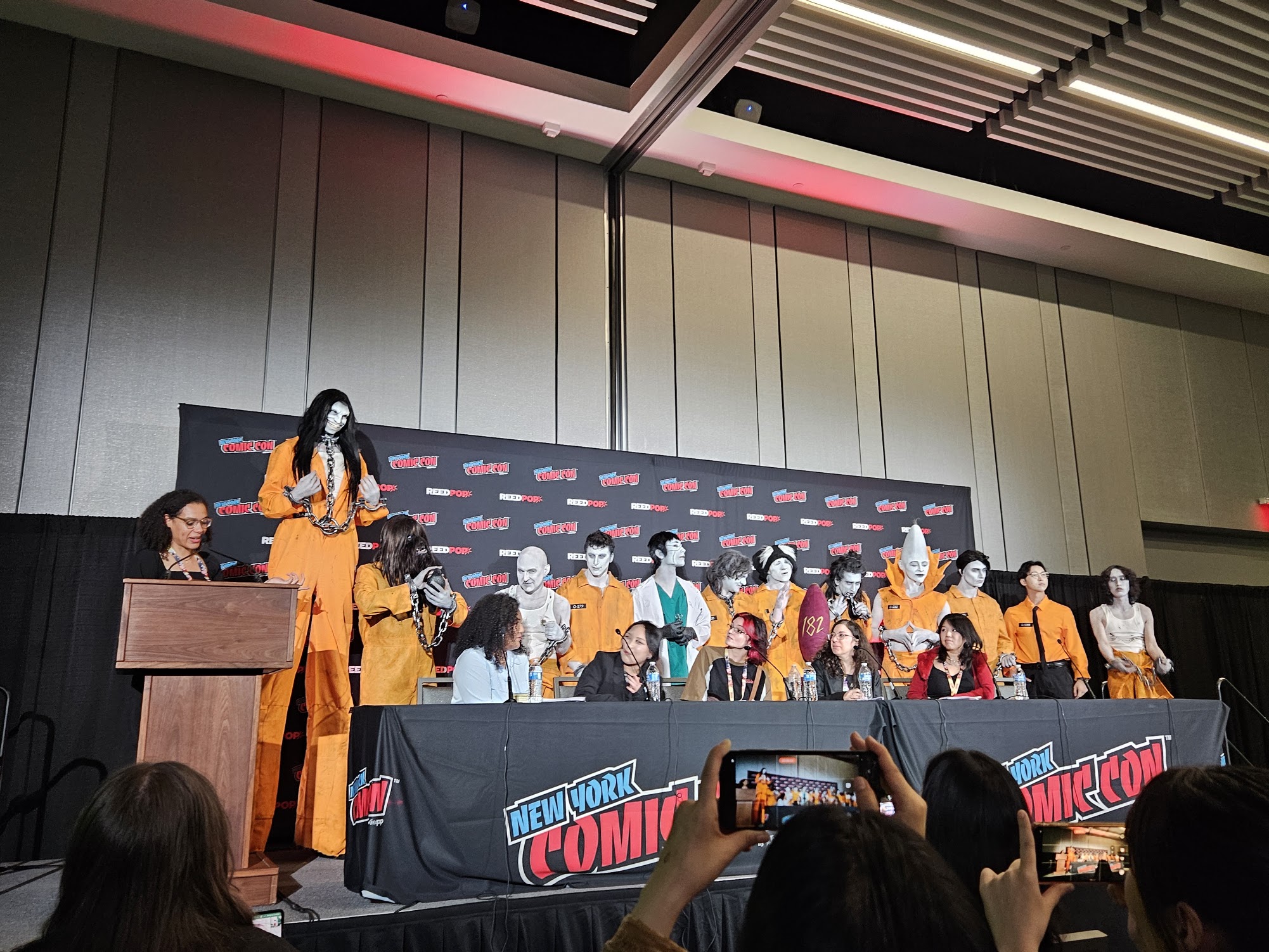 photo of the fog land actors posing behind the panelists